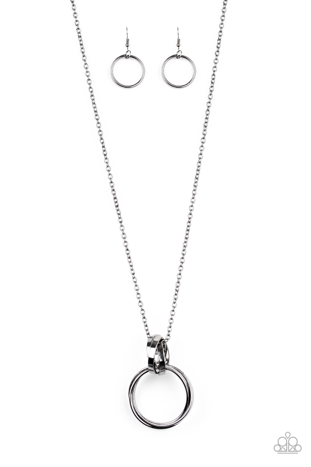 Trios of exaggerated gunmetal rings link at the bottom of a lengthened gunmetal chain, creating a dramatic industrial pendant. Features an adjustable clasp closure. Sold as one individual necklace. Includes one pair of matching earrings.