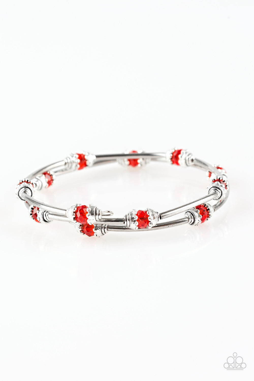 Dainty red crystal-like beads and shimmery silver accents alternate along a coiled wire to create a refined infinity wrap style bracelet. Sold as one individual bracelet.