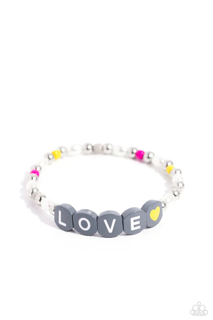 Infused on an elastic stretchy band, white pearls, gray, hot pink, and yellow seed beads, silver studs, and gray beads spelling out the word "LOVE" with a yellow heart bead aside it wraps around the wrist for a sentimental, youthful display. Sold as one individual bracelet.