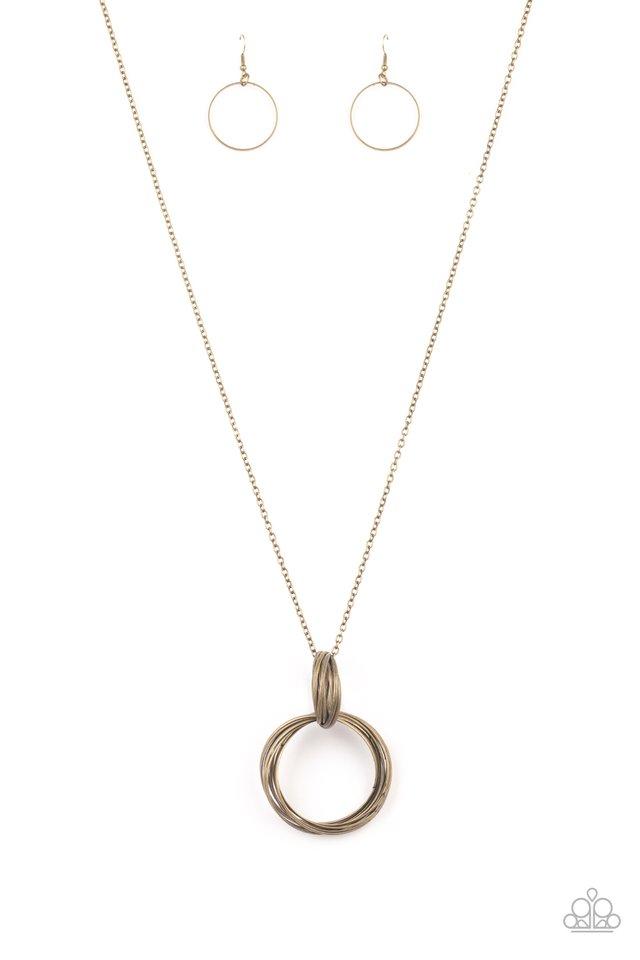 A collection of large and small antiqued brass rings interlock into a bold pendant at the bottom of a lengthened brass chain. Features an adjustable clasp closure.
Sold as one individual necklace. Includes one pair of matching earrings.