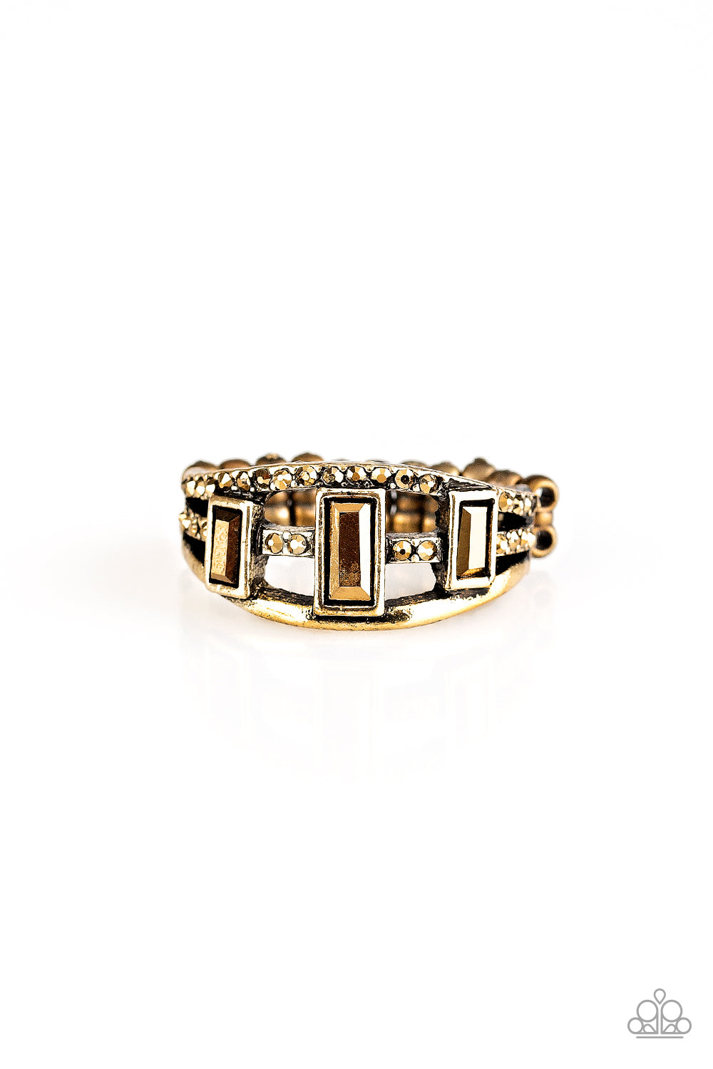Three aurum emerald-cut rhinestones are encrusted along three brass bands radiating with smooth surfaces and sections of glittery aurum rhinestones for an edgy fashion. Features a stretchy band for a flexible fit. Sold as one individual ring.