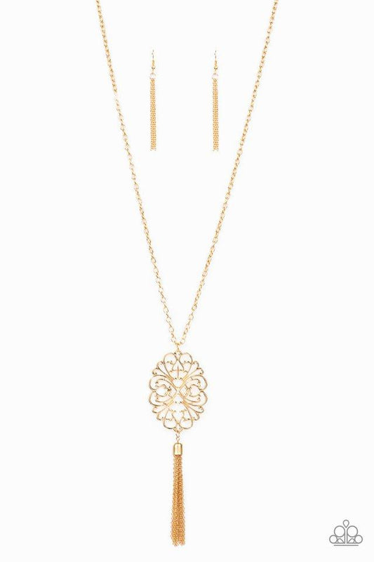 Swirling with filigree detail, a mandala-like pendant gives way to a glistening brass tassel at the end of a lengthened brass chain for a whimsical look. Features an adjustable clasp closure.  Sold as one individual necklace. Includes one pair of matching earrings.