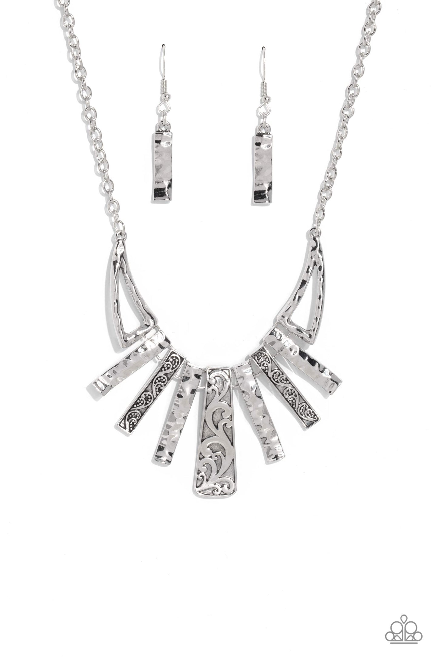 Streaming from a glittery silver chain, warped silver bars with a hammered sheen alternate between warped bars featuring an embossed paisley pattern for a garden statement. Abstract triangles, in the same hammered sheen border the abstract bar display for additional attention-drawing detail down the neckline. Features an adjustable clasp closure. Sold as one individual necklace. Includes one pair of matching earrings.