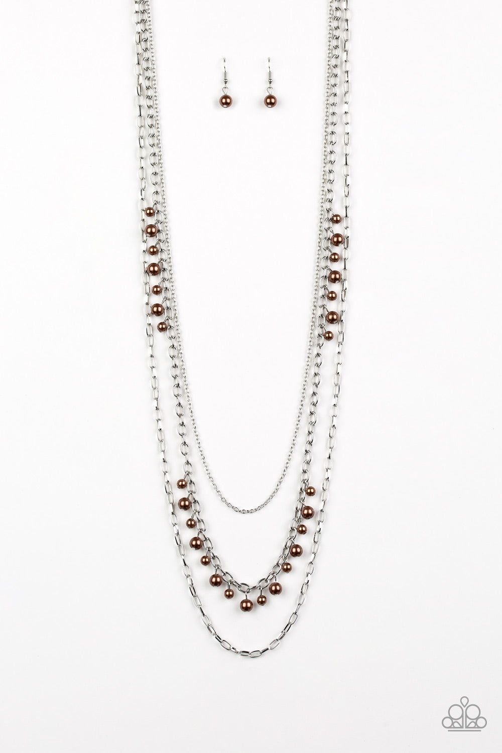 Three mismatched silver chains layer down the chest. Dainty brown pearls cascade down one silver chain, adding a flirty twist to the timeless pearl palette. Features an adjustable clasp closure. Sold as one individual necklace. Includes one pair of matching earrings.