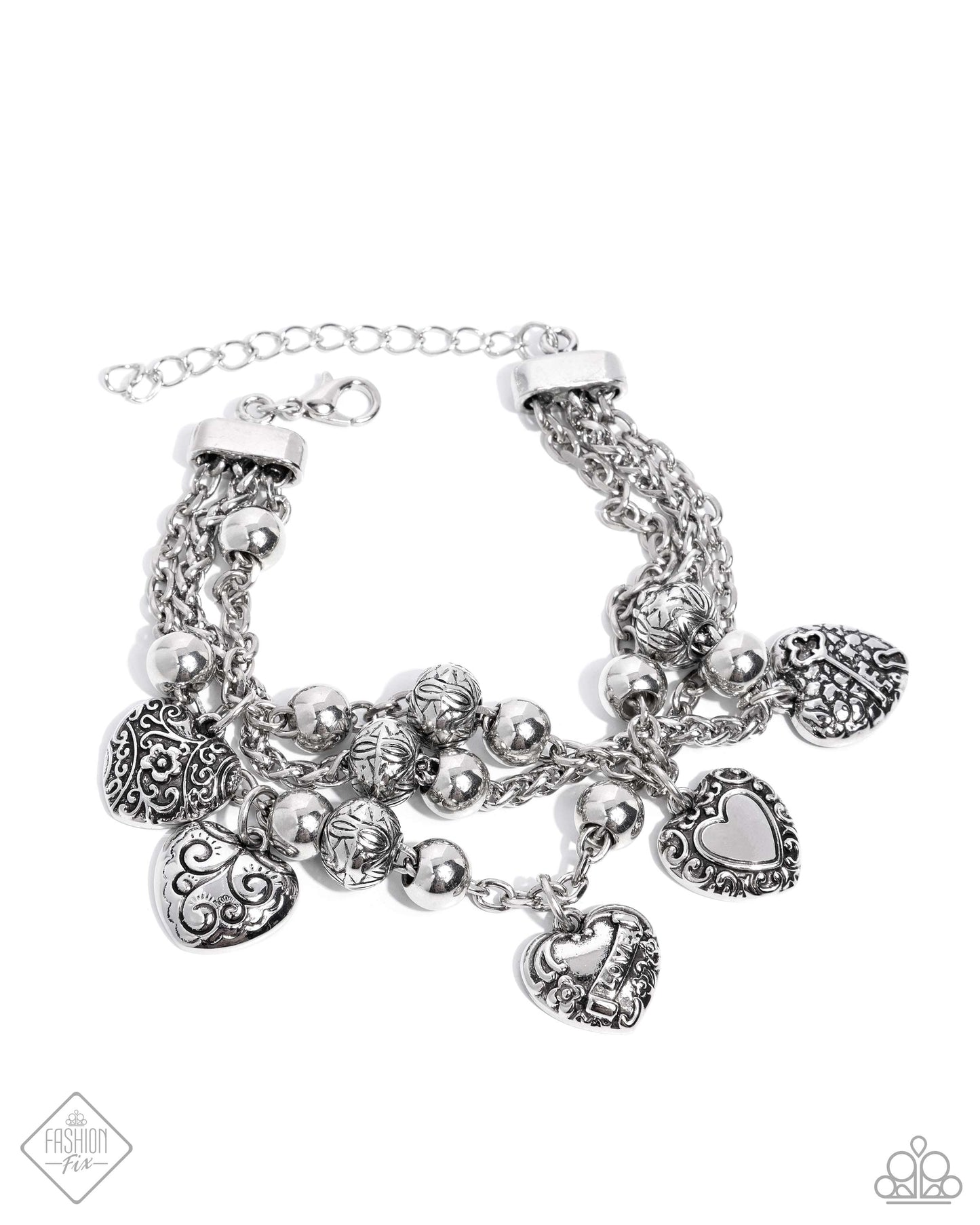 Spanning from silver fittings, a collection of classic silver chains spans around the wrist. Decorative floral and romantic-inspired filigree is embellished across a multitude of heart charms and silver beads while solid silver beads are also infused along the chains for a rustic, radiant display. Features an adjustable clasp closure. Sold as one individual bracelet.