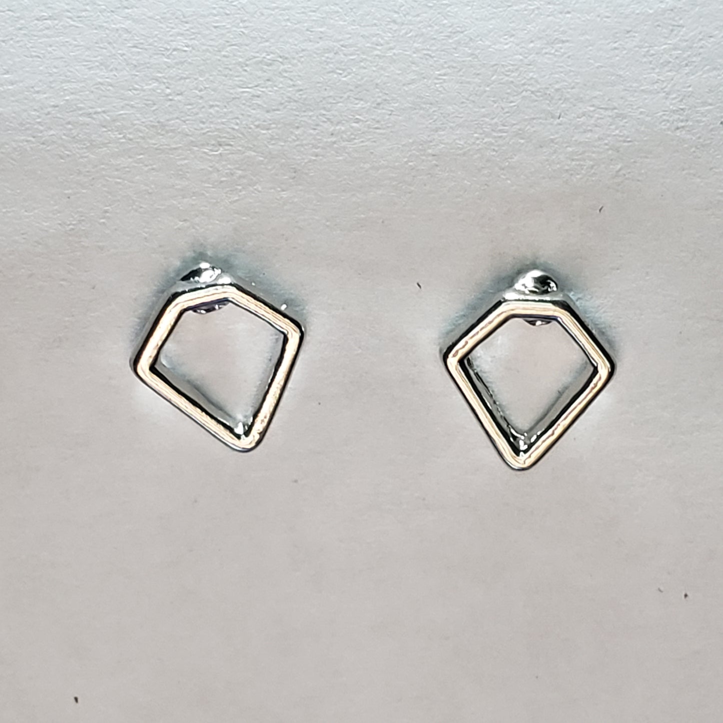 Kid's silver earring shaped like a diamond