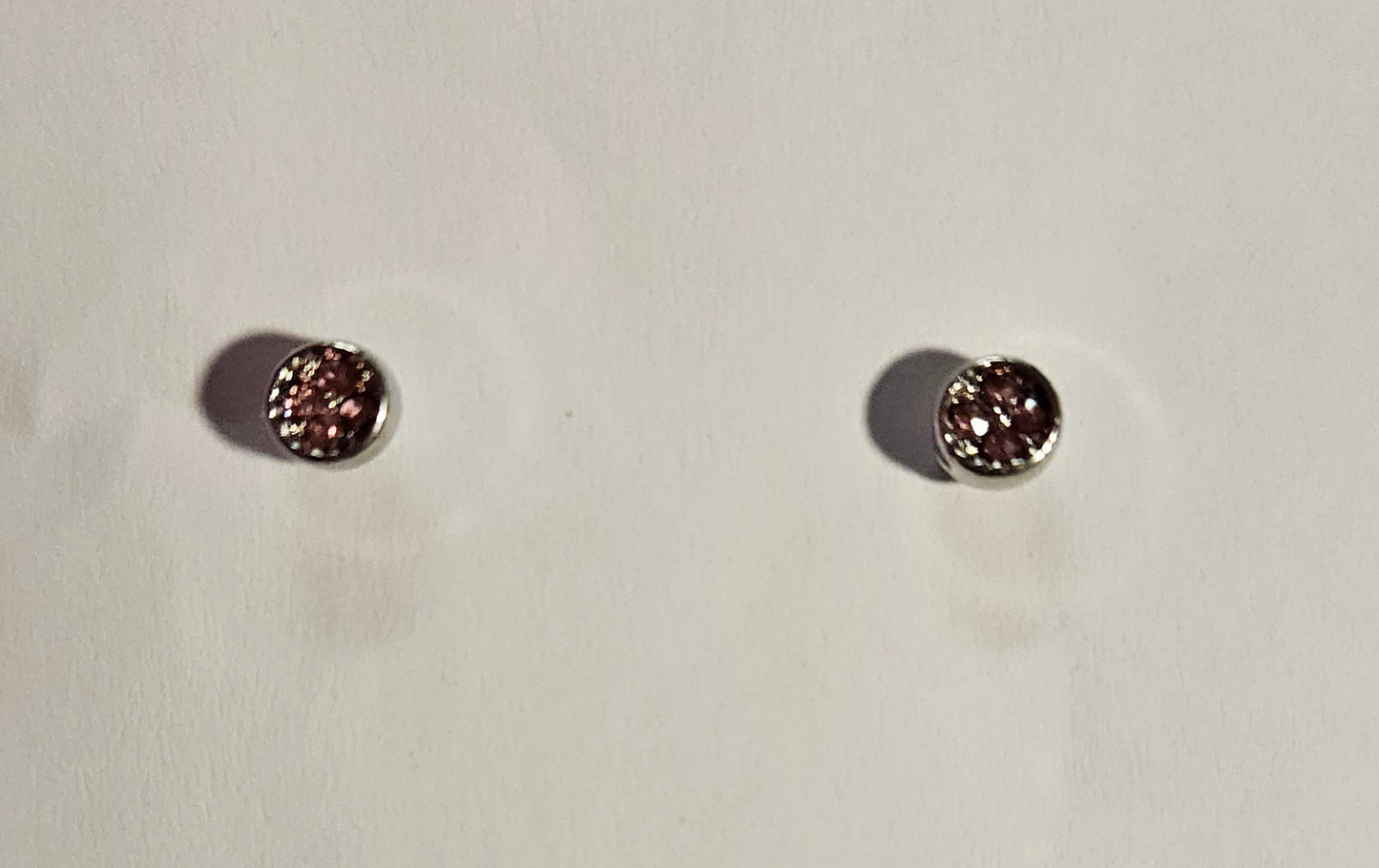 Kids' small silver cirlce earrings with a four small pink rhinestones