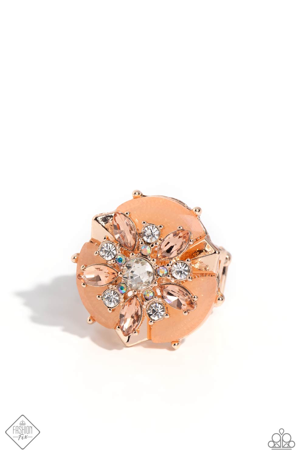 Modeled after a sand dollar motif, peachy marquise-cut gems and round white and iridescent rhinestones explode from a white rhinestone center atop a shimmery rose gold disc accented with shimmery Tender Peach marquise-cut beads. Faceted rose gold bars alternate between each Tender Peach bead for additional dimension. Features a stretchy band for a flexible fit. Due to its prismatic palette, color may vary. Sold as one individual ring.