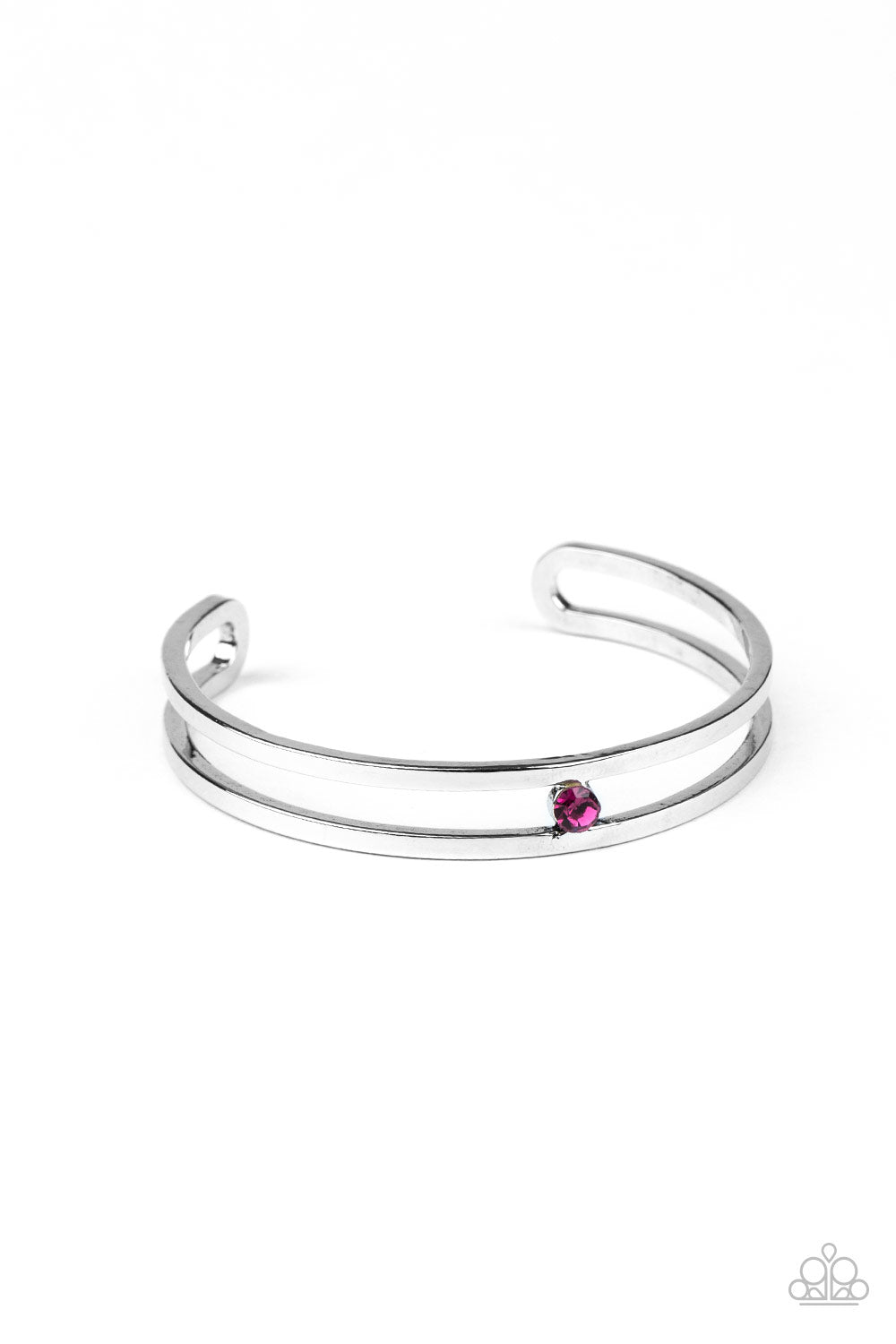A dainty Pink Peacock rhinestone is nestled inside the center of an airy silver cuff, adding a glittery pop of color to the wrist. Sold as one individual bracelet.