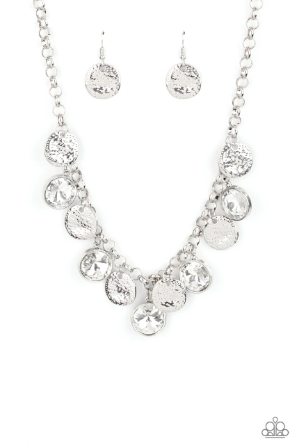 A blinding collection of hammered silver discs and oversized white gems swing from the bottom of a bold silver chain, creating noise-making sparkle below the collar. Features an adjustable clasp closure. Sold as one individual necklace. Includes one pair of matching earrings.