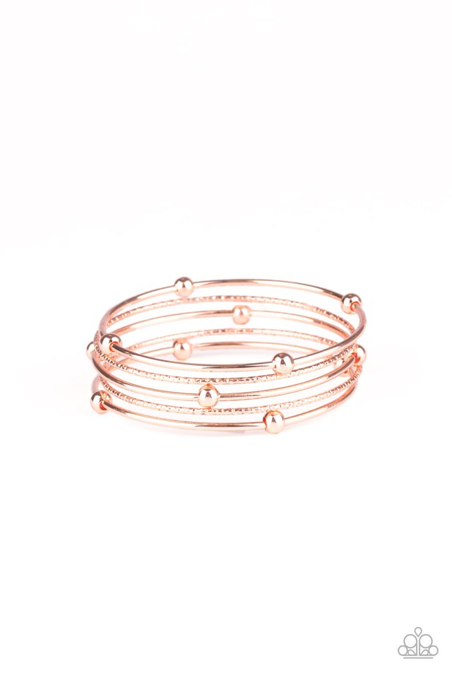 A pair of delicately hammered shiny copper bangles joins a trio of shiny copper beaded bangles around the wrist, creating a collision of metallic texture. Sold as one set of five bracelets.