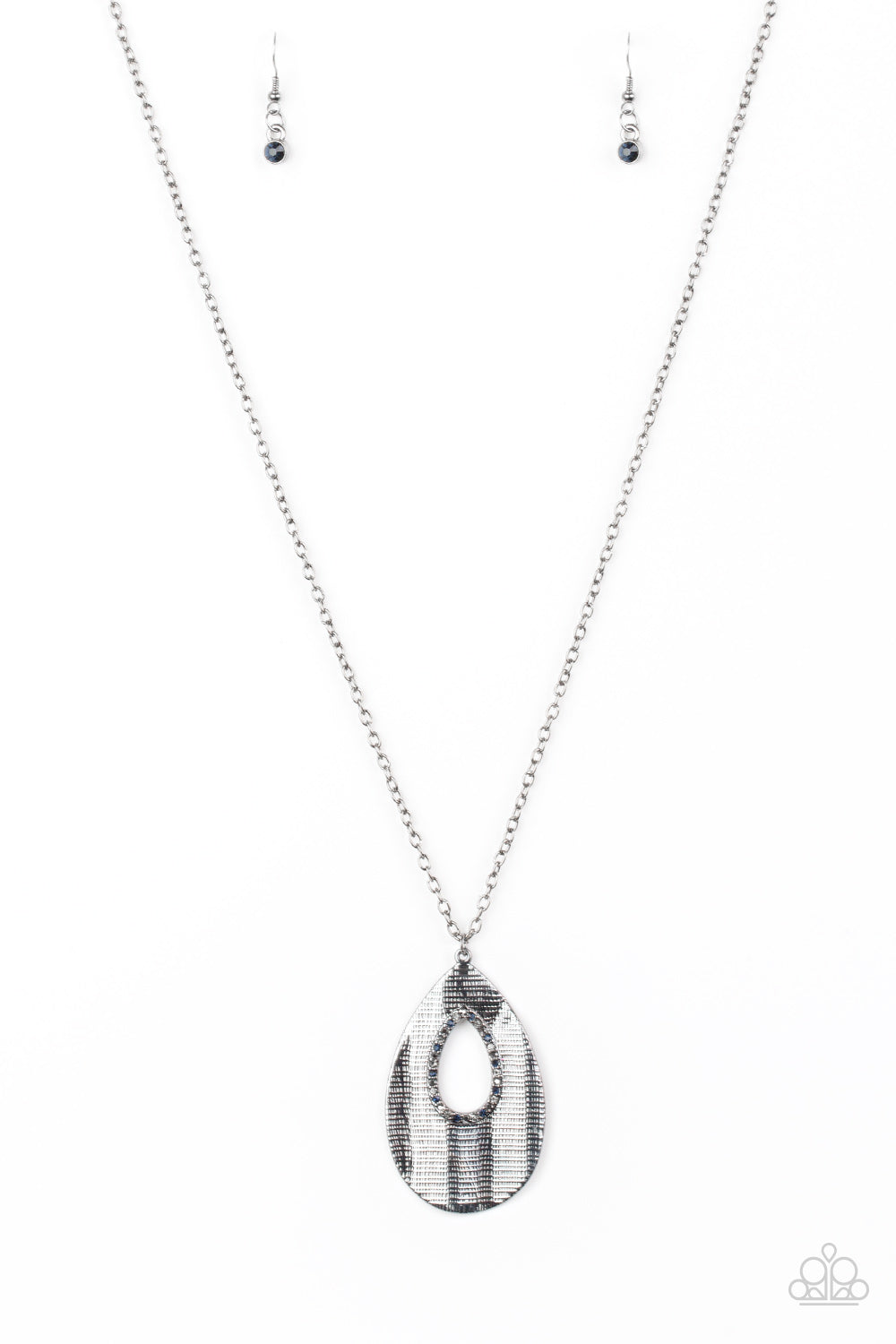 Embossed in a linear geometric pattern, a warped gunmetal teardrop swings from the bottom of a lengthened gunmetal chain. Glittery hematite rhinestones are encrusted around the center of the teardrop pendant for a sparkling finish. Features an adjustable clasp closure. Sold as one individual necklace. Includes one pair of matching earrings.