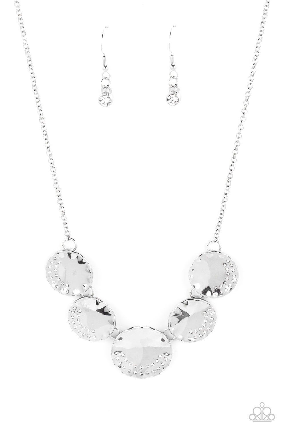 Embossed on the curve of a scalloped edge, a collection of dainty white rhinestones shimmer on a row of reflective, silver discs. The raised edges of the disc, due to its concave center, scatter light and glitz in every direction. Features an adjustable clasp closure. Sold as one individual necklace. Includes one pair of matching earrings.