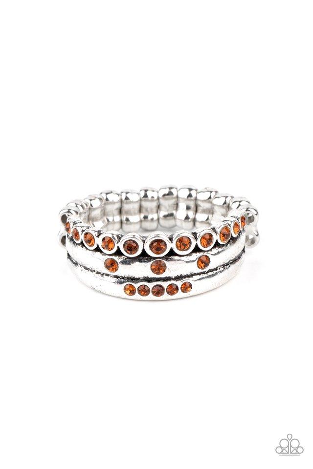 Sporadically dotted in glittery topaz rhinestones, three dainty silver bands layer across the finger for an exceptionally sparkly look. Features a dainty stretchy band for a flexible fit. Sold as one individual ring.