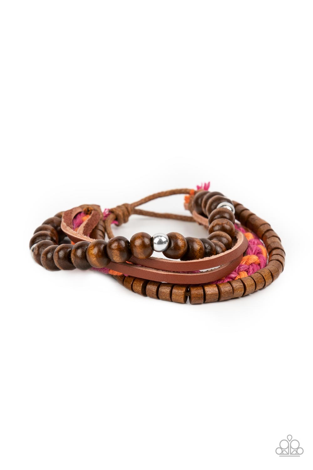 A braid of pink and orange twine-like cording joins strands of mismatched wooden beads and dainty leather bands around the wrist, layering into a colorfully earthy display. Features an adjustable sliding knot closure. Sold as one individual bracelet.