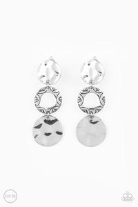 Stamped in a radiant sunburst pattern, a shimmery silver hoop links between two hammered silver discs, creating an artisan inspired lure. Earring attaches to a standard clip-on fitting. Sold as one pair of clip-on earrings.