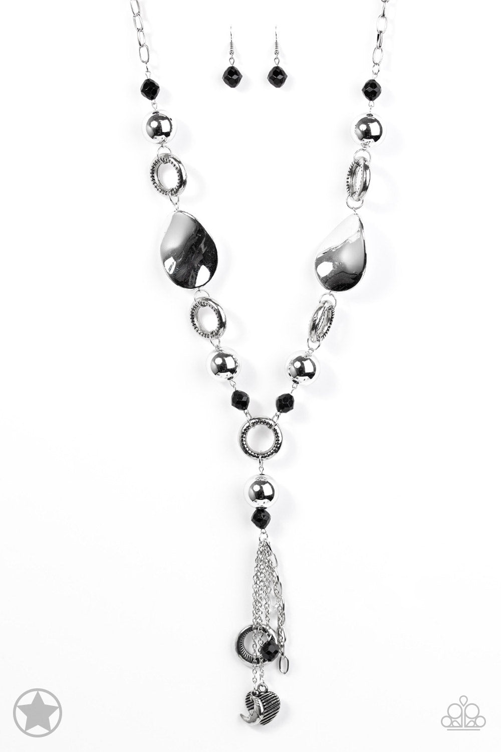 Long chain of black crystalized beads, curved plates of silver with a pearly finish, and chunky silver rings lead down to a tassel of chains and charms, including a crescent moon and a heart. Sold as one individual necklace. Includes one pair of matching earrings.
