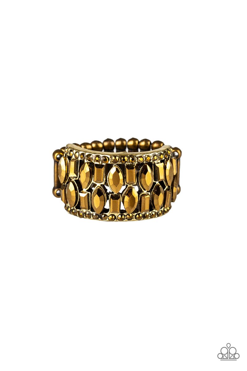 Featuring round, emerald, and marquise style cuts, glittery aurum rhinestones stack across the finger for a glamorous shimmer. Features a stretchy band for a flexible fit. Sold as one individual ring.