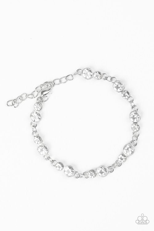 Varying in size, pairs of glassy white rhinestones are encrusted along glistening silver frames and linked around the wrist for a timeless finish. Features an adjustable clasp closure.
Sold as one individual bracelet.