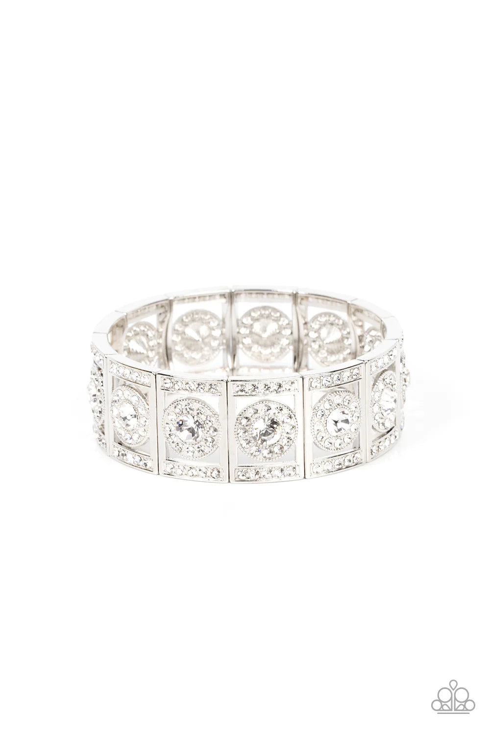 A glassy white rhinestone is pressed into a ring of glitzy white rhinestones inside a rectangular silver frame dusted in dazzling white rhinestones. The timeless frames sparkle along stretchy bands around the wrist, resulting in a glamorously glittering centerpiece. Sold as one individual bracelet.