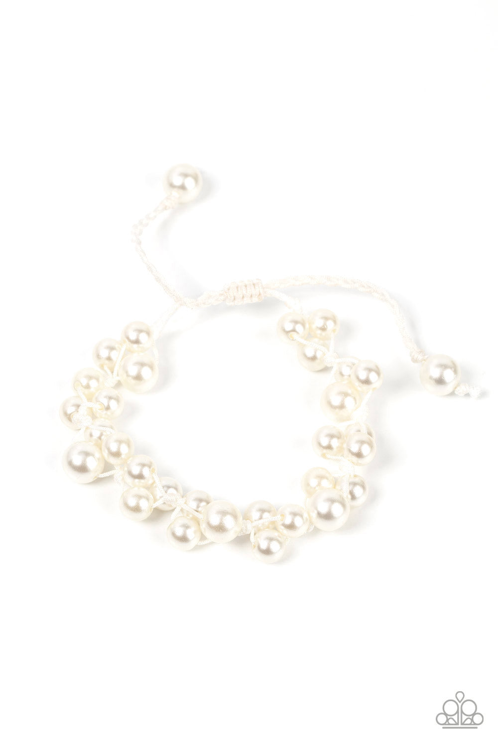 Bubbly clusters of white pearls are decoratively knotted around the wrist, adding a timeless twist to the elegant centerpiece. Features an adjustable sliding knot closure. Sold as one individual bracelet.