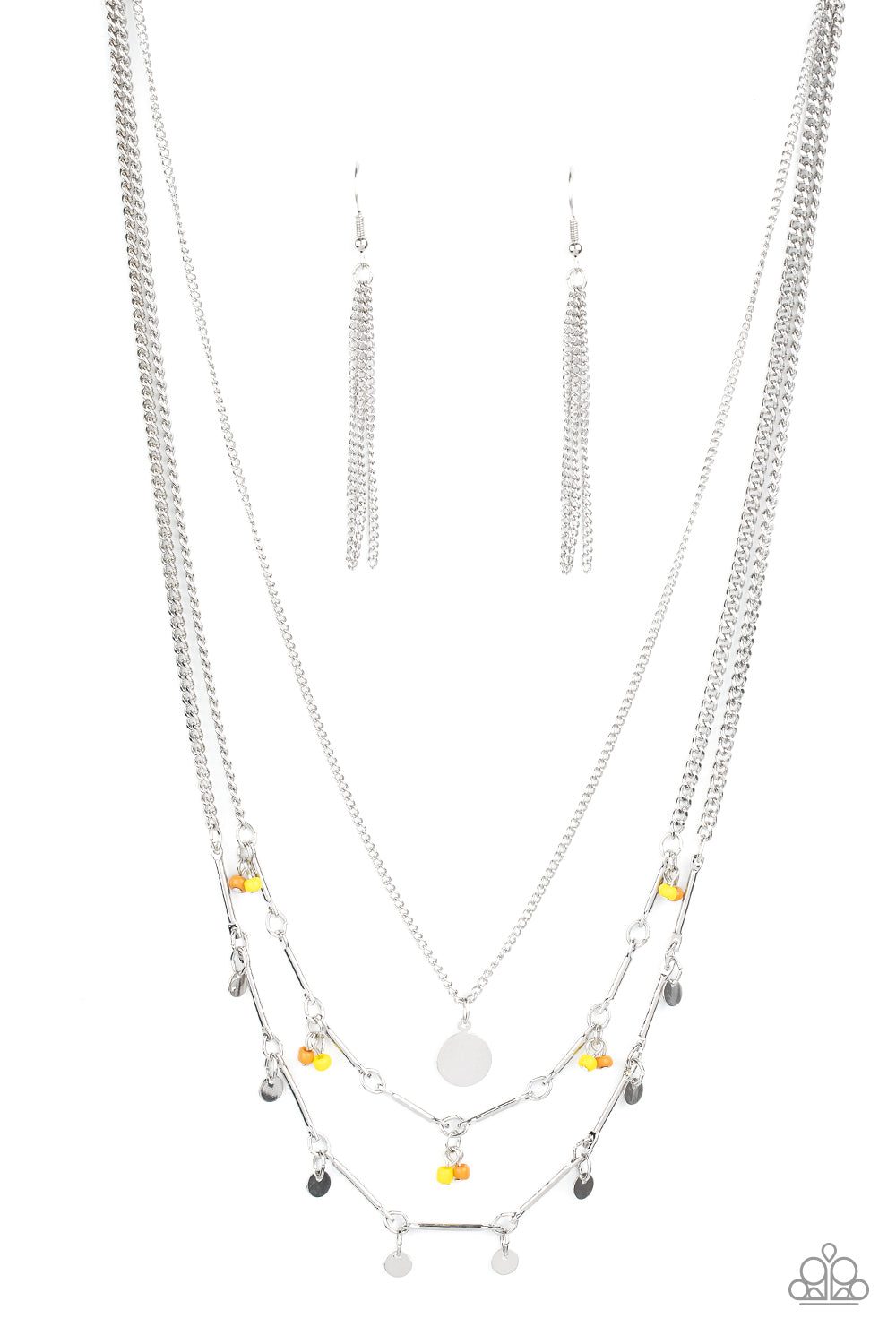 A silver disc is suspended above two mismatched silver chains featuring a mismatched array of silver bars, silver discs, and pairs of brown and yellow seed beads. The dainty display delicately layers below the collar, creating a colorful fringe. Features an adjustable clasp closure. Sold as one individual necklace. Sold as one individual necklace. Includes one pair of silver fringe earrings.