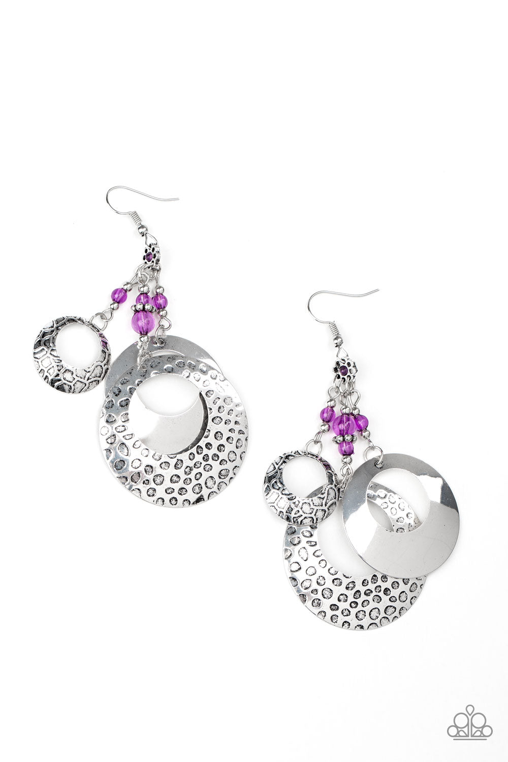 Featuring dainty silver and glassy Magenta Purple beaded tassels, smooth and hammered hoop-like rings swing from a purple beaded floral frame, creating a whimsical lure. Earring attaches to a standard fishhook fitting. Sold as one pair of earrings.