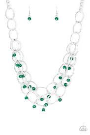 Green crystal-like beads swing from two layers of oversized silver links below the collar for a refined look. Features an adjustable clasp closure. Sold as one individual necklace. Includes one pair of matching earrings.