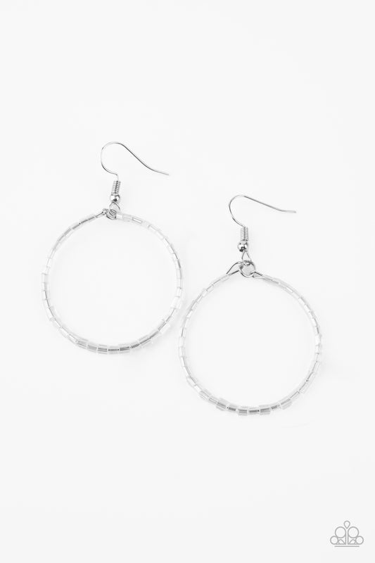 Featuring an iridescent shimmer, glassy white seed beads are threaded along a dainty wire hoop for a colorful finish. Earring attaches to a standard fishhook fitting.  Sold as one pair of earrings.