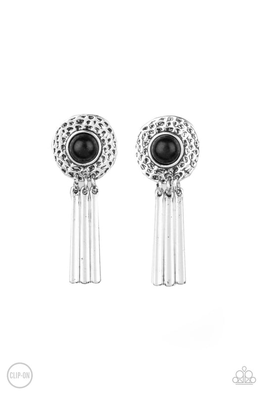 Dotted with an earthy black stone center, a hammered silver frame gives way to a fringe of shiny silver bars for a seasonal flair. Earring attaches to a standard clip-on fitting.  Sold as one pair of clip-on earrings.