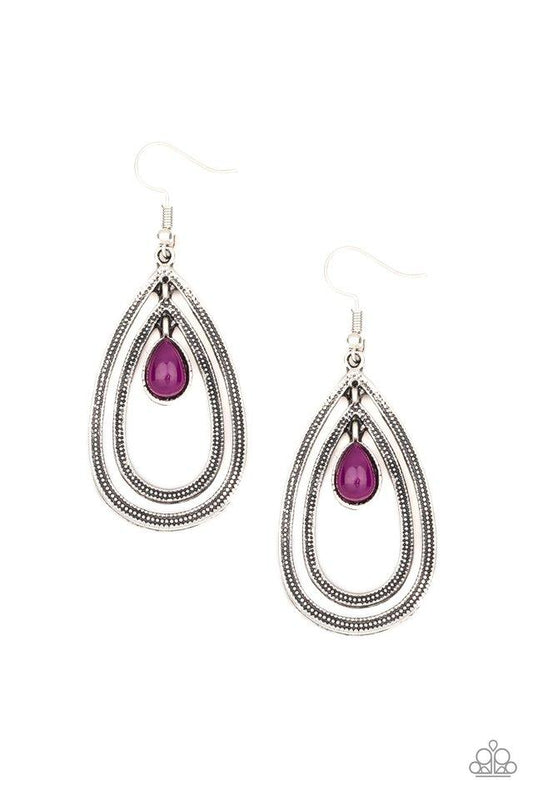 A purple teardrop bead is nestled inside two silver teardrops radiating in studded textures, creating a dizzying lure. Earring attaches to a standard fishhook fitting.  Sold as one pair of earrings.