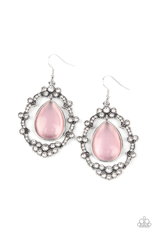 A teardrop pink cat's eye stone swings from the top of an ornately white rhinestone encrusted frame, creating an icy lure. Earring attaches to a standard fishhook fitting.  Sold as one pair of earrings.