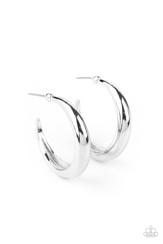 A thick silver bar curls into a dainty crescent shaped hoop for a classic finish. Earring attaches to a standard post fitting. Hoop measures approximately 1" in diameter.  Sold as one pair of hoop earrings.