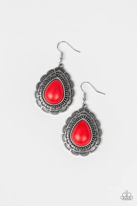 Chiseled into a tranquil teardrop, a fiery red stone is pressed into a scalloped silver frame radiating with tribal inspired patterns for a seasonal look. Earring attaches to a standard fishhook fitting.  Sold as one pair of earrings.