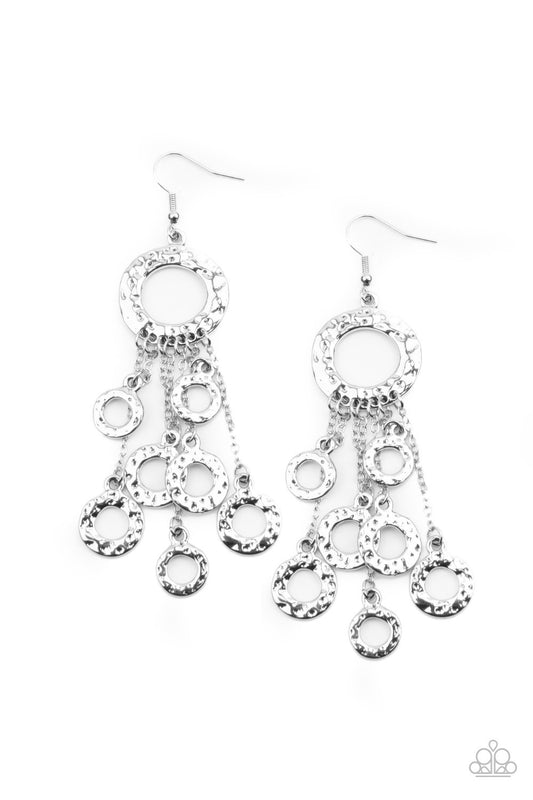 Attached to dainty silver chains, a fringe of hammered silver rings swings from the bottom of a matching hammered ring for a noise-making statement. Earring attaches to a standard fishhook fitting.  Sold as one pair of earrings.