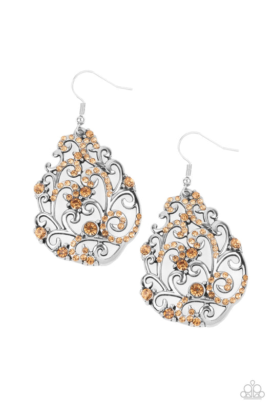 Dotted in an array of glittery golden topaz rhinestones, shiny silver filigree climbs the ear, coalescing into a vine-like teardrop frame. Earring attaches to a standard fishhook fitting.  Sold as one pair of earrings.