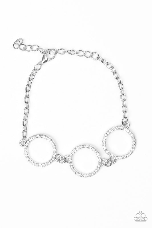Encrusted in glassy white rhinestones, three glittery silver rings link across the wrist for a glamorous look. Features an adjustable clasp closure.

Sold as one individual bracelet.