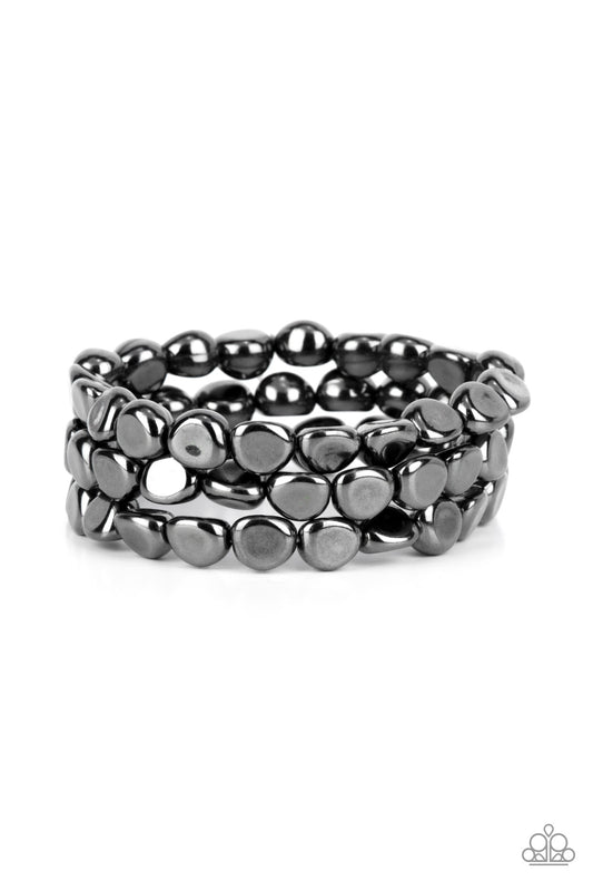 Featuring irregular stone shapes, a shiny series of gunmetal beads are threaded along stretchy bands around the wrist for a bold pop of monochromatic magic.

Sold as one set of three bracelets.