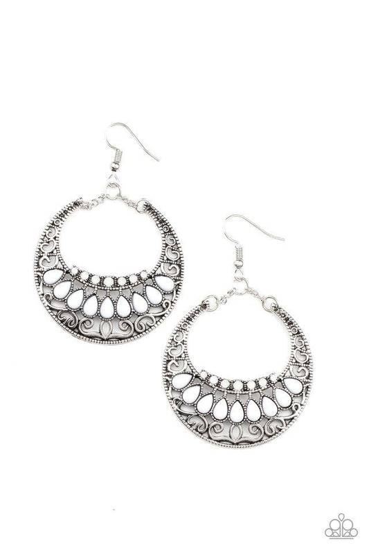Faceted in light-reflecting textures, a beveled silver hoop swings from the ear for an edgy shine. Earring attaches to a standard fishhook fitting.  Sold as one pair of earrings.