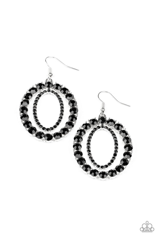 An oversized ring of glittery black rhinestones encircle a dainty ring of black rhinestones, stacking into a blinding frame. Earring attaches to a standard fishhook fitting.  Sold as one pair of earrings.