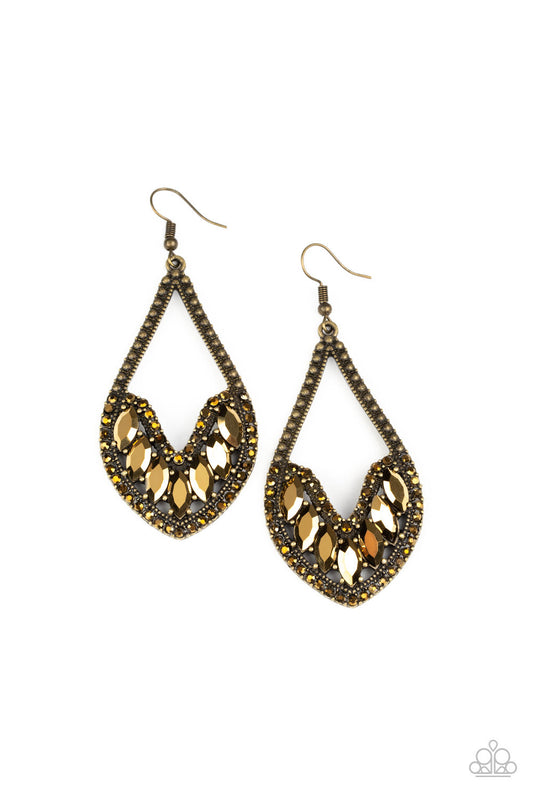 Bordered in sections of dainty aurum rhinestones and antiqued brass studs, the bottom of an elongated brass teardrop is embellished in edgy marquise style aurum rhinestones for an epic finish. Earring attaches to a standard fishhook fitting.  Sold as one pair of earrings.