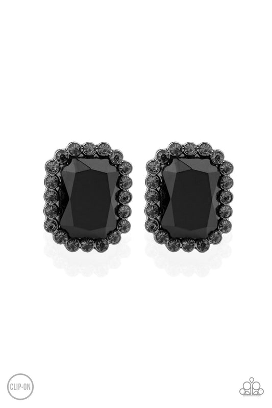 A regal black gem is bordered by a frame of glittery smoky rhinestones for an edgy look. Earring attaches to a standard clip-on fitting.  Sold as one pair of clip-on earrings.