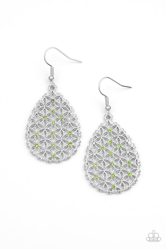 Dainty green rhinestones are encrusted across the front of a silver teardrop frame filled with ornate tactile filigree, creating a whimsical lure. Earring attaches to a standard fishhook fitting  Sold as one pair of earrings.