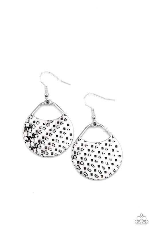The front of a uniquely shaped silver frame is stamped and hammered in slanting rows of square and dotted patterns for a one-of-a-kind look. Earring attaches to a standard fishhook fitting.  Sold as one pair of earrings.