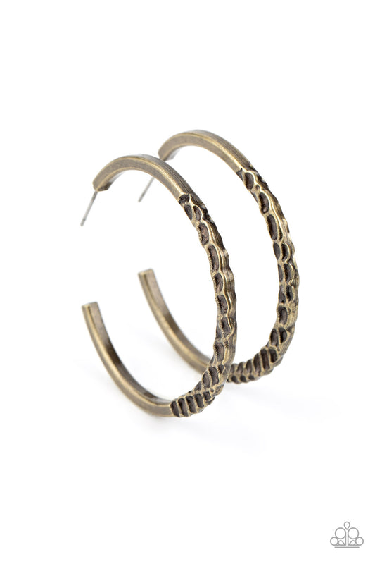 The bottom of a dainty brass hoop has been dramatically hammered in gritty texture for an intense industrial finish. Earring attaches to a standard post fitting. Hoop measures approximately 1 3/4" in diameter.  Sold as one pair of hoop earrings.