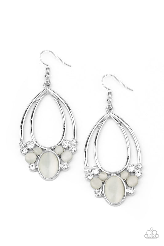 A glamorous collection of glittery white rhinestones and dewy white cat's eye stones collect at the bottom of two stacked silver teardrop frames, creating an enchanted fringe. Earring attaches to a standard fishhook fitting.  Sold as one pair of earrings.