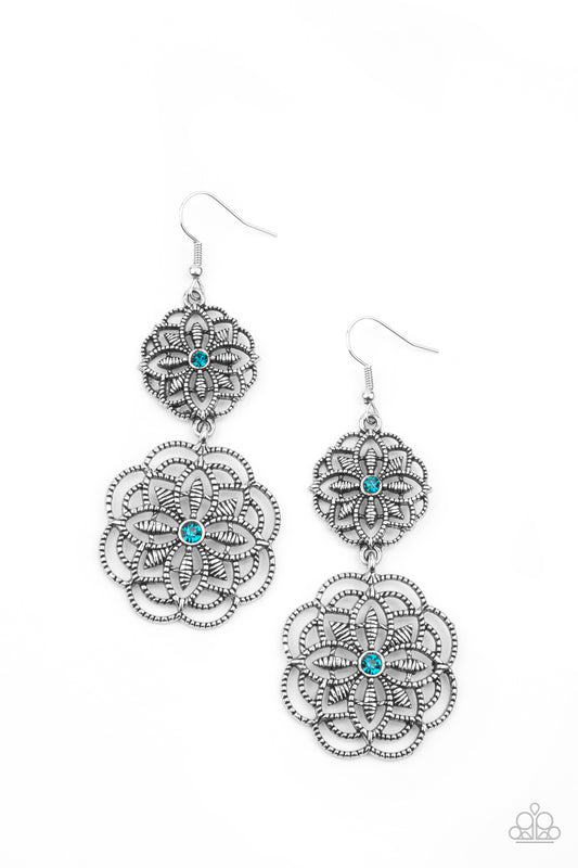 Dotted with dainty blue rhinestone centers, studded mandala-like silver frames connect into a whimsical floral lure. Earring attaches to a standard fishhook fitting.

Sold as one pair of earrings.