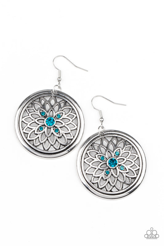 Dotted with a glittery blue rhinestone center, airy silver petals bloom across the front of a rustic silver hoop, creating a sparkly medallion-like frame. Earring attaches to a standard fishhook fitting.

Sold as one pair of earrings.