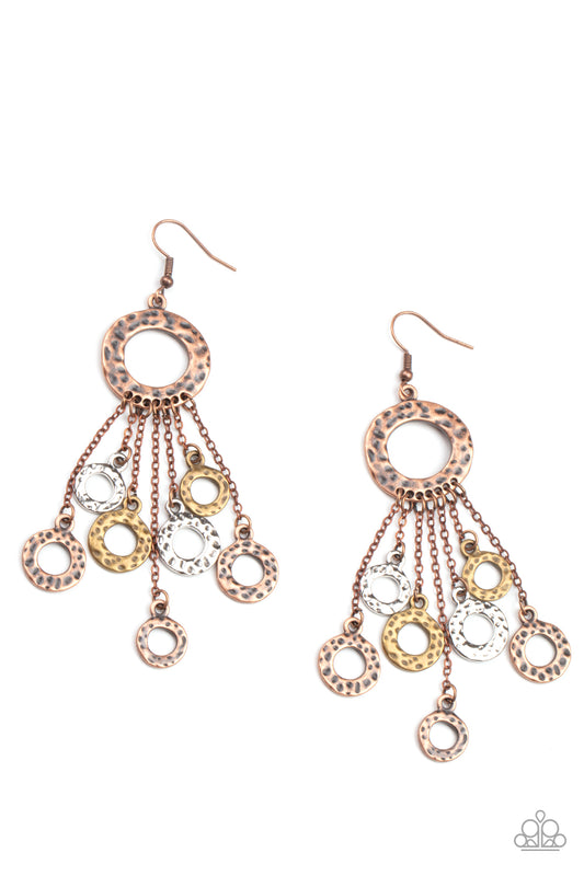 Attached to dainty copper chains, a fringe of hammered brass, copper, and silver rings swings from the bottom of a hammered copper ring for a noise-making statement. Earring attaches to a standard fishhook fitting.  Sold as one pair of earrings.