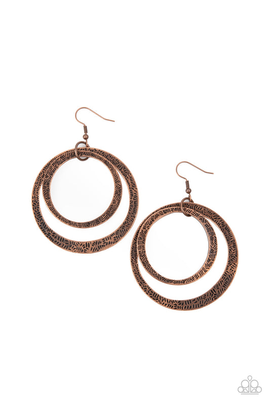 Stamped in tactile linear patterns, two asymmetrical copper rings link into a rustic hoop. Earring attaches to a standard fishhook fitting.

Sold as one pair of earrings.